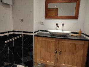 a bathroom with a sink and a mirror on a counter at Chambre d'hôte lozérienne in Saint-Privat-du-Fau