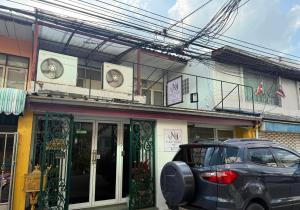 a car parked in front of a building at Casa Nicola BKK in Ban Na Song