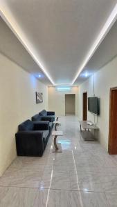 a living room with couches and a flat screen tv at شقق مفروشة الباحة in Al Baha