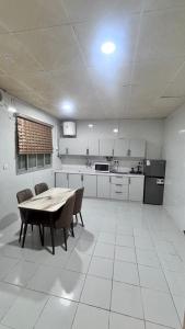 a kitchen with a table and chairs in a room at شقق مفروشة الباحة in Al Baha
