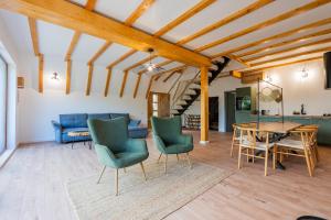 a living room with a blue couch and a table at The Cliff Village in Comarnic