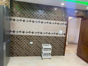 a bathroom with a tiled wall with a walk in shower at Perle de Soliman Plage in Soliman