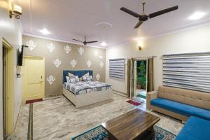 a living room with a bed and a couch at Sambhariya Bagh Resort in Kānota