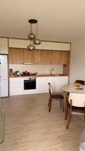 a kitchen with a table and a table and chairs at Modinakhe in Kobuleti