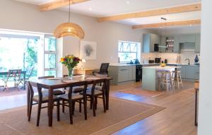 a kitchen and living room with a wooden table and chairs at Scandi House in Louis Trichardt