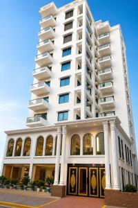 a large white building with at Royal Richmond Hotel in Dhaka