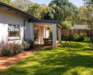 a patio with a table in a yard at Scandi House in Louis Trichardt