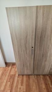 a wooden door in a room with a wooden floor at Apartmán pro 2 osoby, Bukovany B3 in Sokolov
