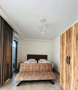 a bedroom with a large bed with a wooden headboard at Modinakhe in Kobuleti +14 photos