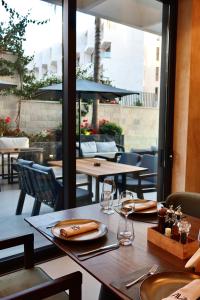 a table with glasses and napkins on it at a restaurant at Avanel Signature in Sarandë