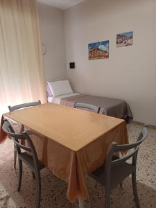 a room with two beds and a table and chairs at B&b del corso in Santa Ninfa +8 photos