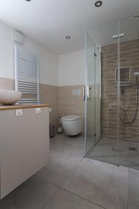 a bathroom with a shower and a tub and a sink at Elbsandsteinlodge in Sebnitz +22 photos
