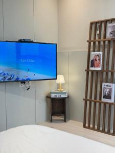 a bedroom with a large flat screen tv on a wall at Mood Ocean 인천 영종도 in Chagyak-to