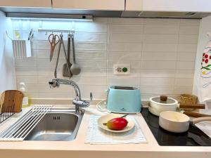 a kitchen with a sink and a bowl of fruit on the counter at Mood Ocean 인천 영종도 in Chagyak-to +13 photos