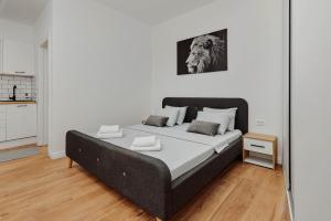 a bedroom with a large bed in a room at Modern Studio Old Town by MN Property in Kotor