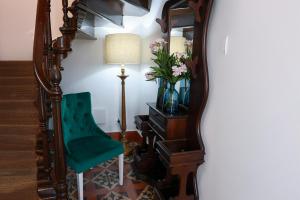 a room with a mirror and a green chair at Casa Ferreira in Olaia +43 photos