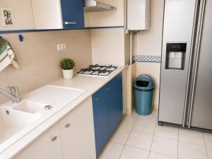 a small kitchen with a sink and a refrigerator at Prestige appart in Chalon-sur-Saône +2 photos
