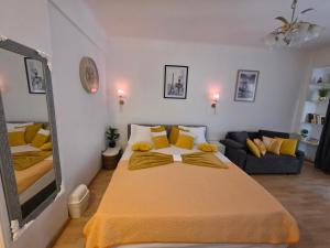 a bedroom with a large bed and a couch at Studio Bulle de Rêve à deux pas du Port in Nice