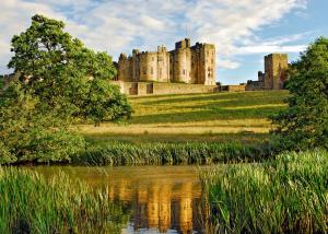 a castle sitting on top of a hill next to a lake at Ellington Escape in Ellington