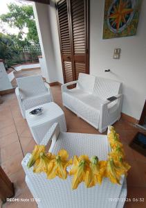 two white wicker chairs with bows on them on a patio at Chalet Nautilus in San Mango Piemonte