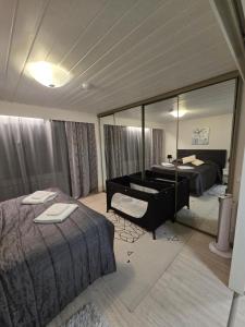 a room with two beds and a mirror at Ketunpesä Puijolla in Kuopio