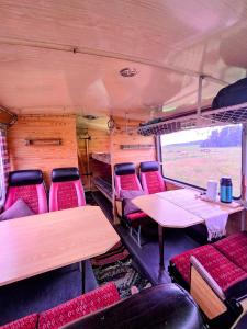 an inside view of a bus with tables and chairs at Retro Saunabuss Valgamaal in Sooblase