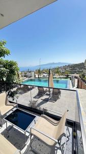 a balcony with chairs and a swimming pool at Saranda's Crown in Sarandë