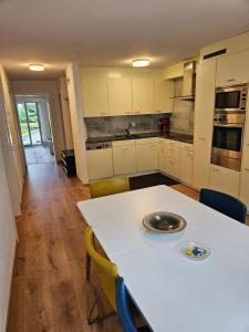 a kitchen with a white table and chairs at Ferienwohnung Sesvenna Davos in Davos