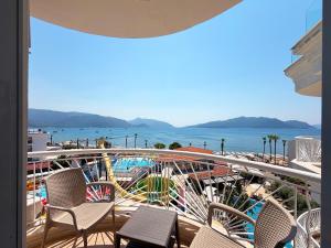 a balcony with chairs and a view of the water at Romance Beach Hotel in Marmaris