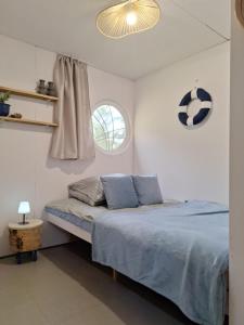 a bedroom with a bed with a soccer ball on the wall at Mazurska Chatka Pilchy in Pilchy