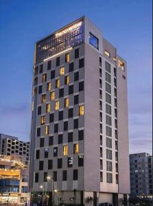 a tall building with many windows in a city at Mood-Ocean 영종도 오션파크나인호텔 in Chagyak-to