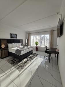 a bedroom with a bed and a desk in it at Flourish Haven Escape in Germiston