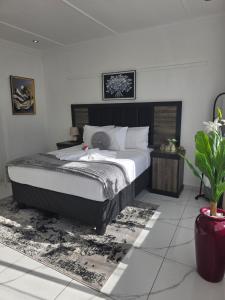 a bedroom with a large bed in a room at Flourish Haven Escape in Germiston