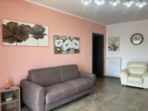 a living room with a couch and a chair at La Quiete dei Tacchi Ulassai in Ulassai