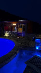 a swimming pool in front of a house at night at Villa Aresini - Dimora Esclusiva in Montemiletto
