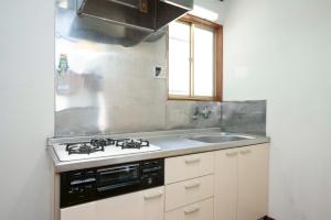 a kitchen with a stove and a sink at 横須賀-1軒家2棟 in Yokosuka +43 photos