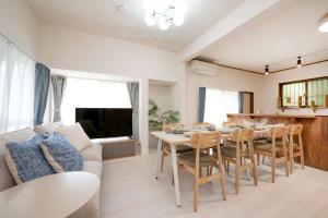 a living room with a couch and a table and chairs at 横須賀-1軒家2棟 in Yokosuka
