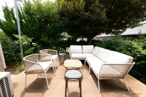a patio with a couch and chairs and a table at 横須賀-1軒家2棟 in Yokosuka