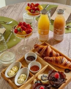 a table with a tray of breakfast foods and drinks at Il Castelluccio Country Resort Restaurant & SPA in Barberino di Mugello