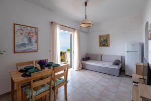 a living room with a table and a couch at Corfu Dream Holidays Villas Standarts in Glyfada