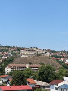 a city with a castle on top of a hill at Apartman S52 City Centre in Doboj