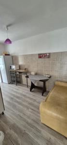 a living room with a table and a couch at Casă Bubu in Cacica +4 photos
