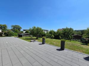 a patio with two potted plants in a park at FeWo Morgenstern in Bad Wildungen +2 photos