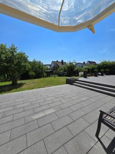 a patio with a bench and a blue sky at FeWo Morgenstern in Bad Wildungen