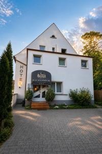 a white building with a sign on the front of it at Hotel Mainbrücke in Kitzingen