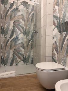 a bathroom with a toilet and a shower at Orchidea Apartments in Sorso