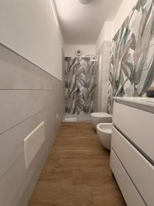 a bathroom with a toilet and a sink at Orchidea Apartments in Sorso +23 photos