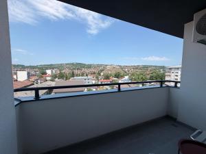 a balcony with a view of a city at Apartman S52 City Centre in Doboj