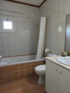a bathroom with a toilet and a tub and a sink at Greenfield House in Psevdhas +13 photos