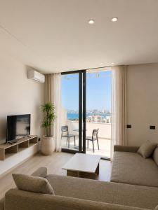 a living room with a couch and a table at Emera Apartments in Vlorë